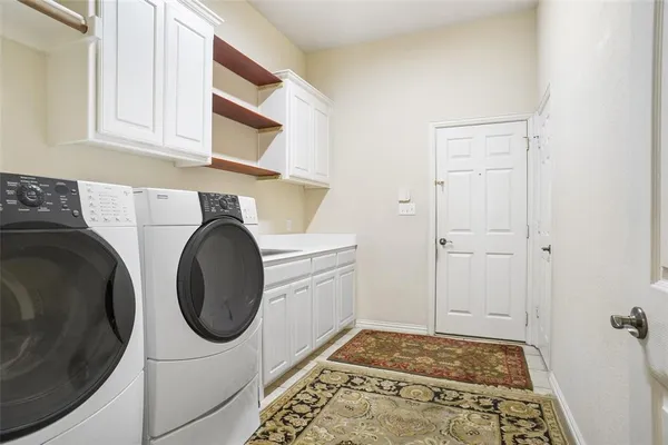 a utility room with sink dryer and washer