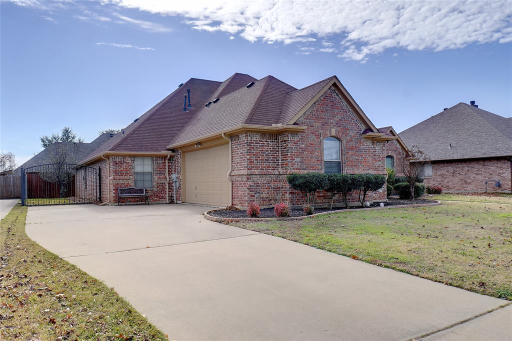756 Trails End Circle Hurst, TX 76054 - Photo 3 of 26 a front view of a house with a garden and yard