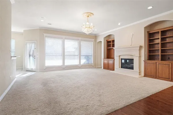 a big room with windows and fireplace