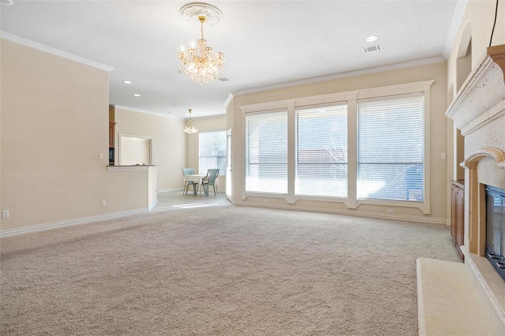 756 Trails End Circle Hurst, TX 76054 - Photo 9 of 26 a big room with windows and a chandelier
