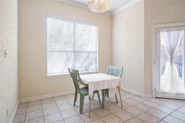 a view of a dining room with furniture and a window