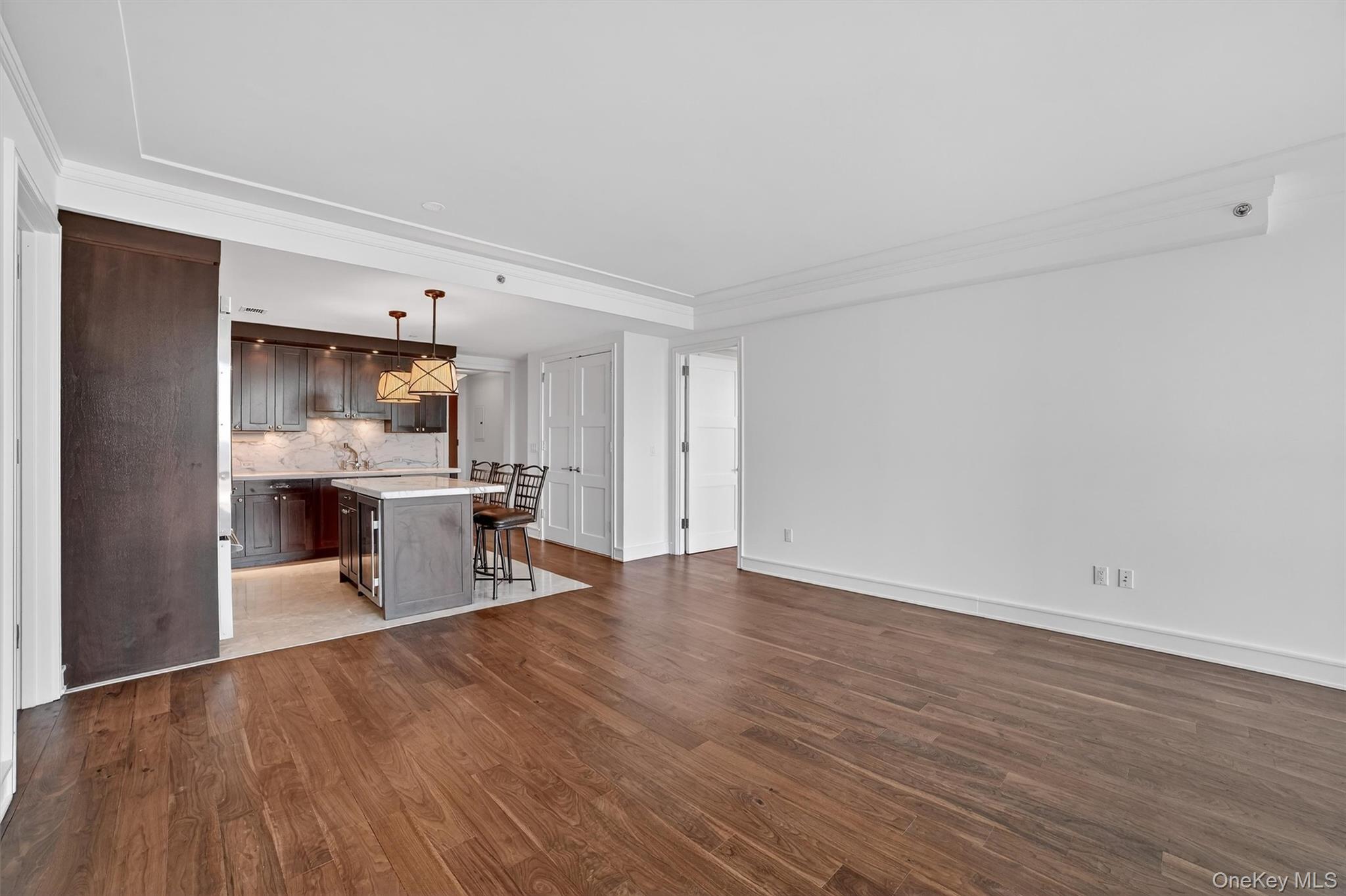 1 Renaissance Square, Unit 26F White Plains, NY 10601 - Photo 14 of 33 a view of a living room and kitchen with furniture wooden floor and a window