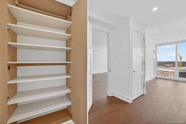 a view of entryway and hall with wooden floor
