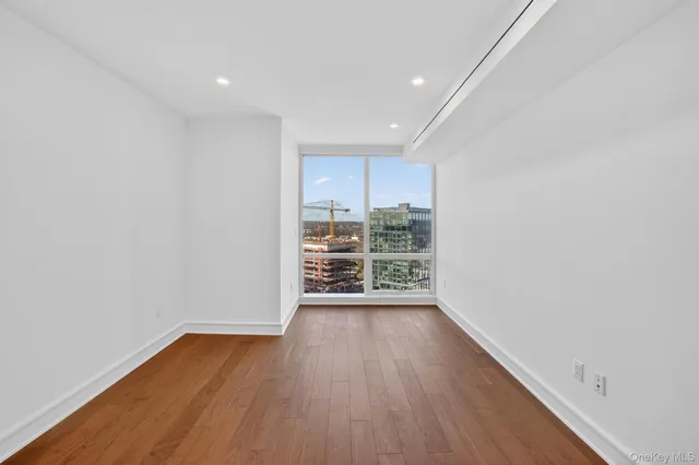 a view of a room with wooden floor and window