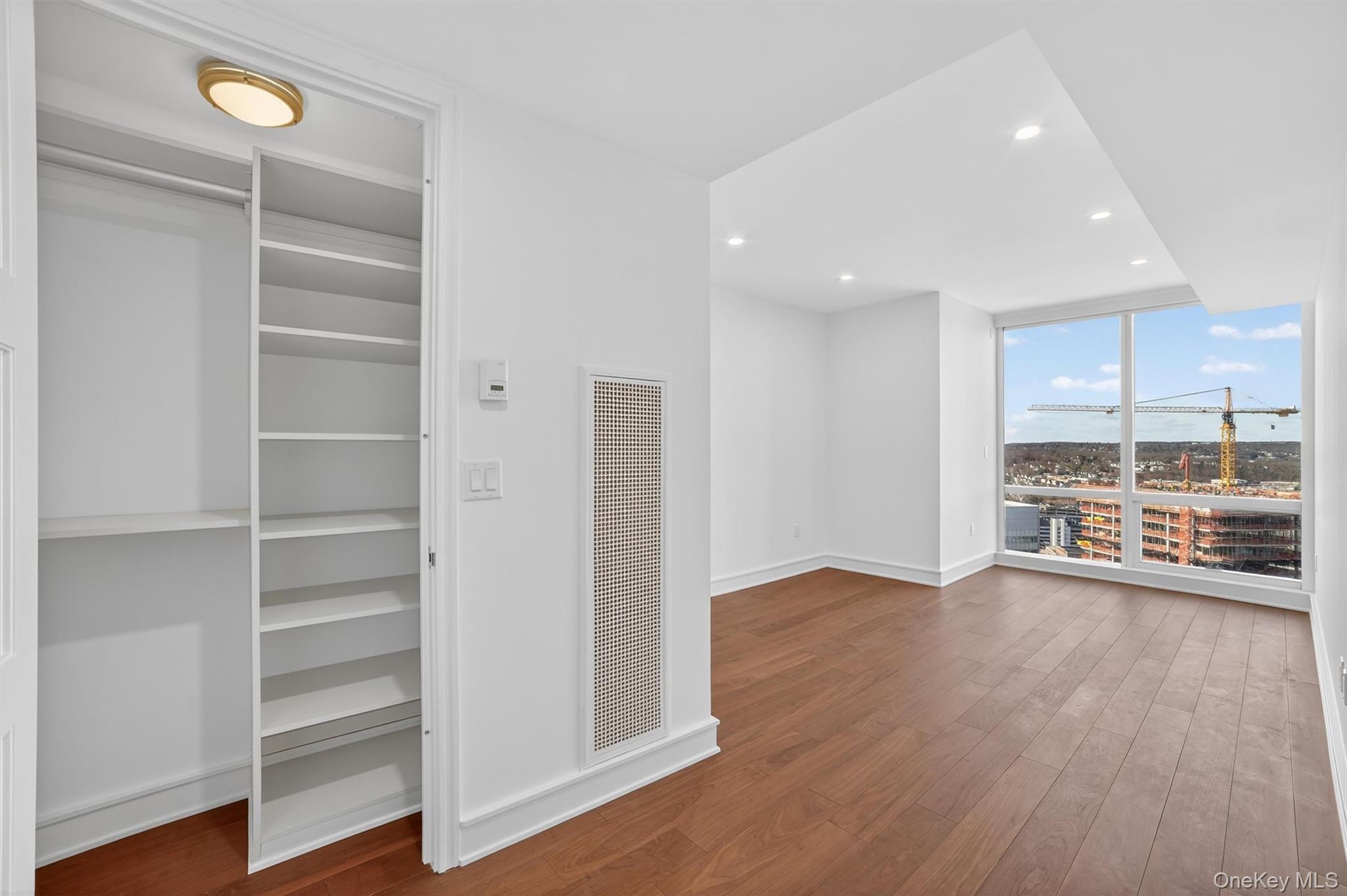 1 Renaissance Square, Unit 26F White Plains, NY 10601 - Photo 32 of 33 a view of an empty room with a window and wooden floor