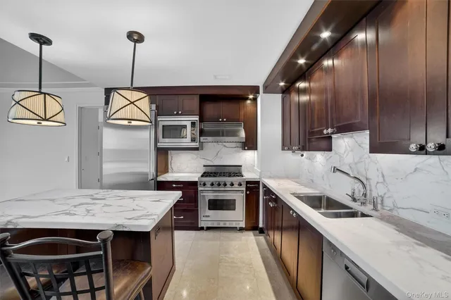 a kitchen with a stove sink and cabinets