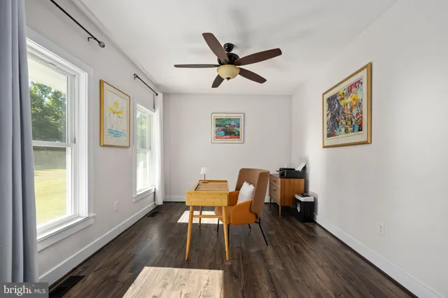 a kitchen with granite countertop white cabinets and sink