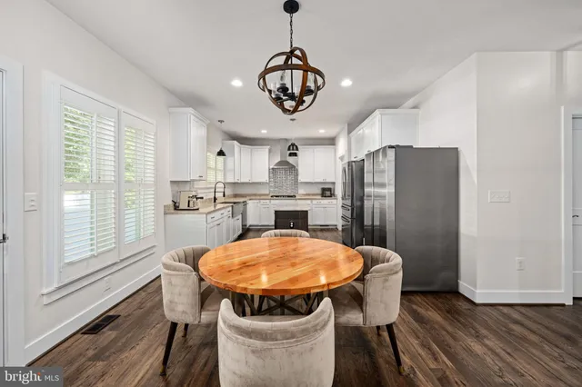 a kitchen with granite countertop a sink and a refrigerator