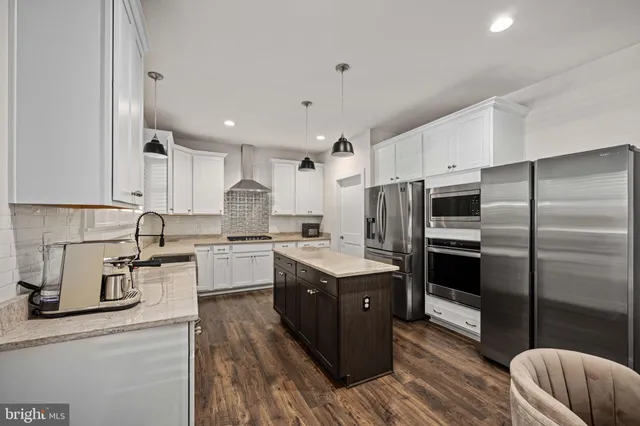 a bathroom with a granite countertop sink two mirror and a