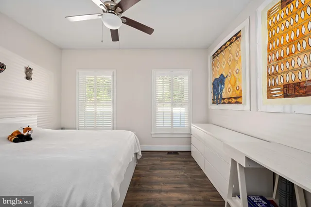 a bathroom with a granite countertop sink mirror toilet and shower