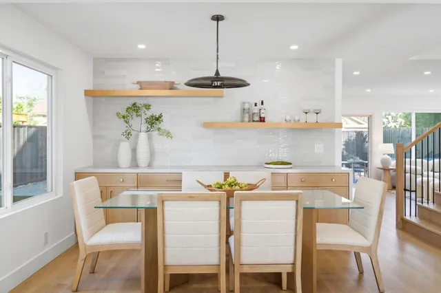 a living room with furniture a table and wooden floor