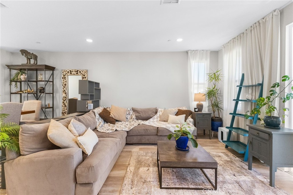 45763 Via Nubes Temecula, CA 92592 - Photo 15 of 63 a living room with furniture and a potted plant