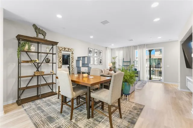 a dining room with furniture and a flat screen tv