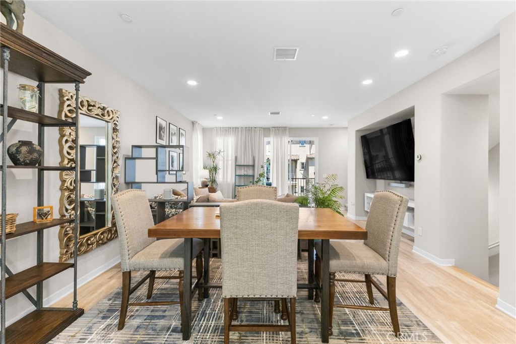 45763 Via Nubes Temecula, CA 92592 - Photo 20 of 63 a dining room with furniture and a flat screen tv