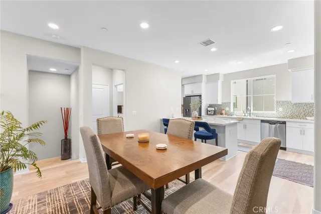 a kitchen with cabinets a sink and chairs in it