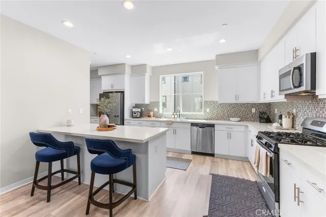 a large white kitchen with a large island