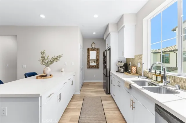 a kitchen with a sink and refrigerator