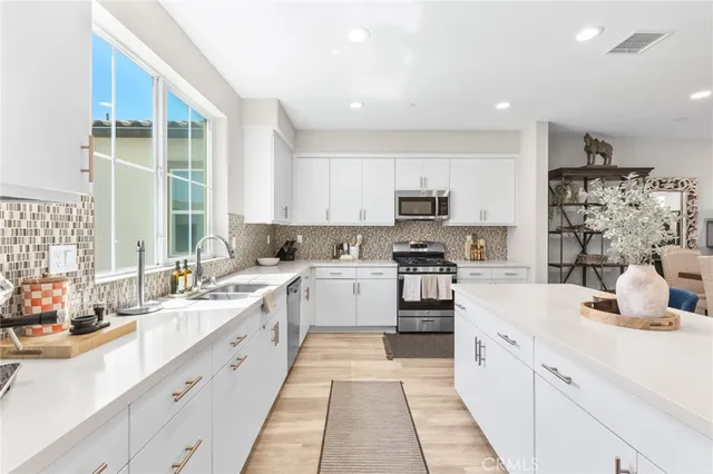 a kitchen with cabinets oven and a sink