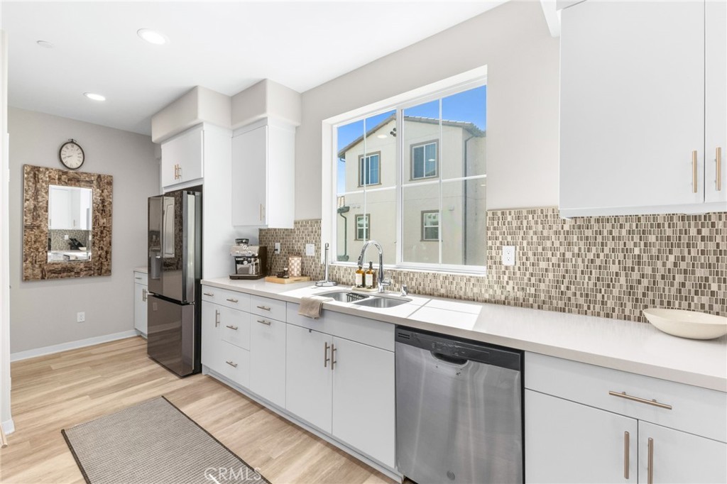 45763 Via Nubes Temecula, CA 92592 - Photo 30 of 63 a kitchen with a sink and refrigerator