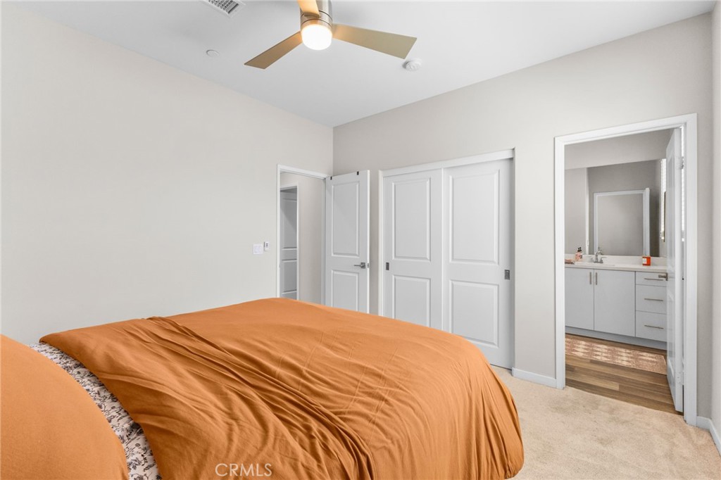 45763 Via Nubes Temecula, CA 92592 - Photo 40 of 63 a bedroom with a bed and a chandelier