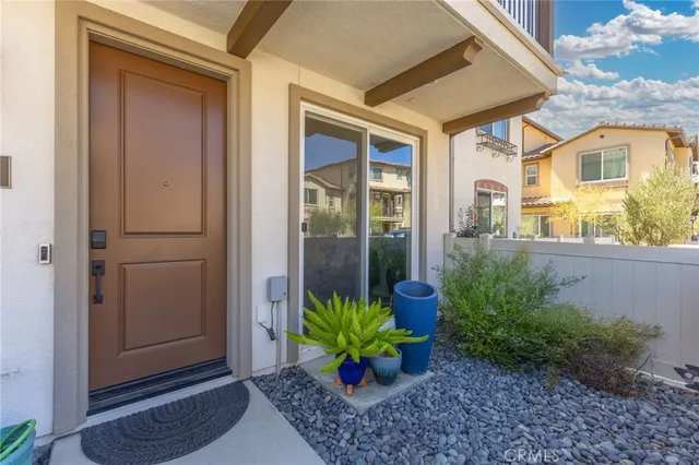 a view of a house with a potted plant and a porch