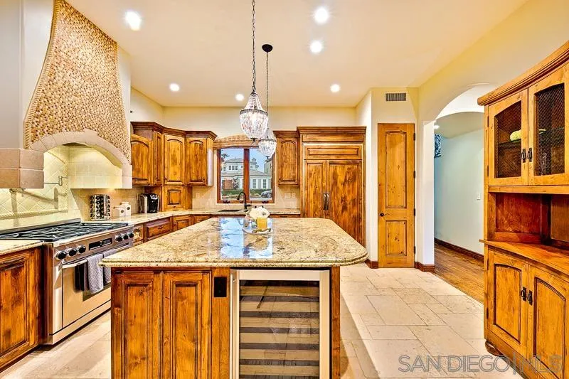7964 Prospect Place La Jolla, CA 92037 - Photo 12 of 46 a kitchen with stainless steel appliances granite countertop a sink a stove and a wooden floors