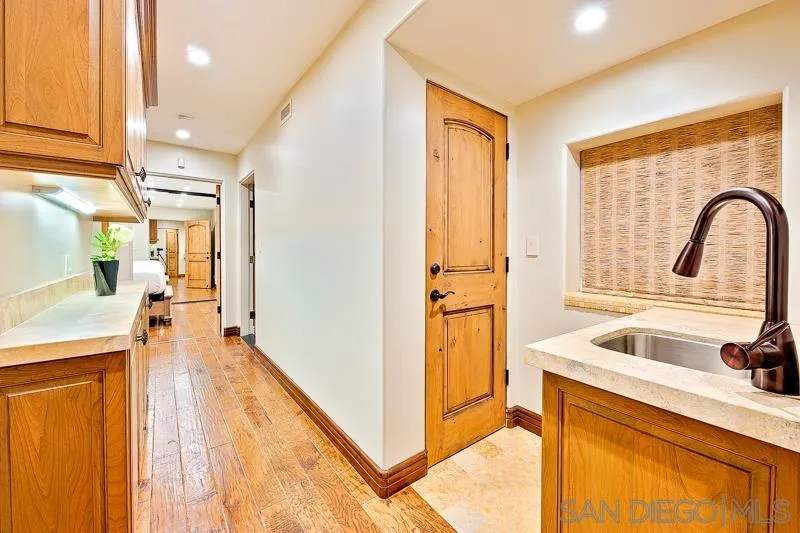 7964 Prospect Place La Jolla, CA 92037 - Photo 23 of 46 a view of a kitchen with a sink and dishwasher with a fireplace