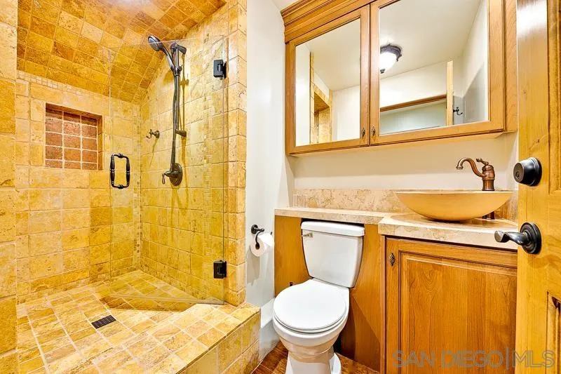 7964 Prospect Place La Jolla, CA 92037 - Photo 24 of 46 a bathroom with a sink and a mirror