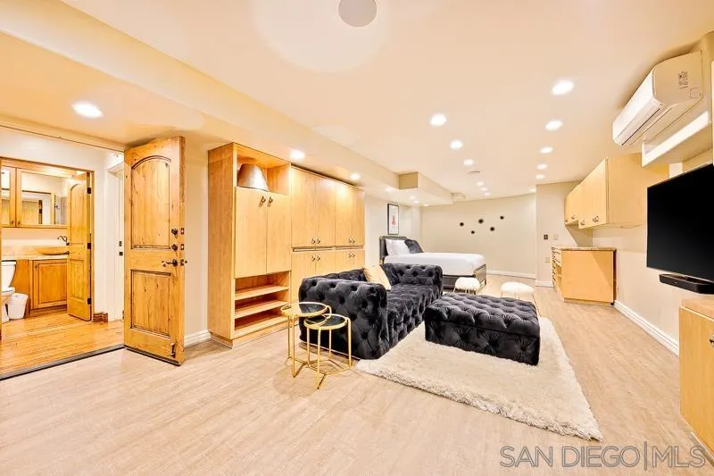 7964 Prospect Place La Jolla, CA 92037 - Photo 28 of 46 a bedroom with furniture and a flat screen tv