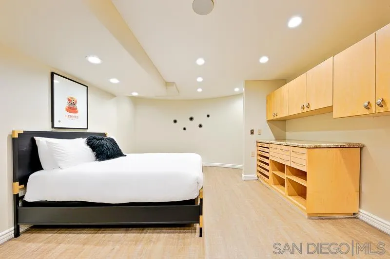 7964 Prospect Place La Jolla, CA 92037 - Photo 29 of 46 a spacious bedroom with a bed and cabinets