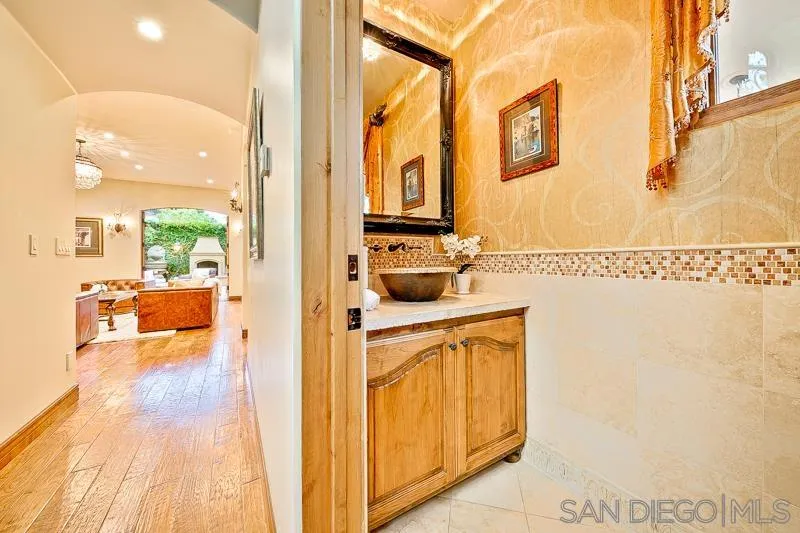 7964 Prospect Place La Jolla, CA 92037 - Photo 3 of 46 a bathroom with a sink and a mirror
