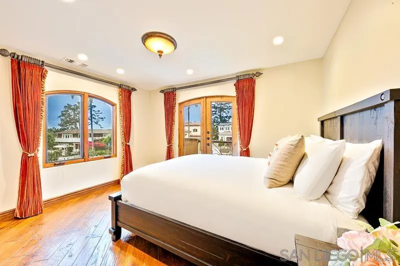 7964 Prospect Place La Jolla, CA 92037 - Photo 32 of 46 a bedroom with a bed and wooden floor