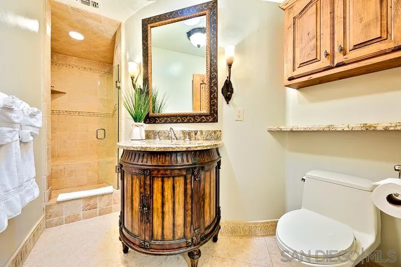 7964 Prospect Place La Jolla, CA 92037 - Photo 33 of 46 a bathroom with a toilet a sink and a mirror
