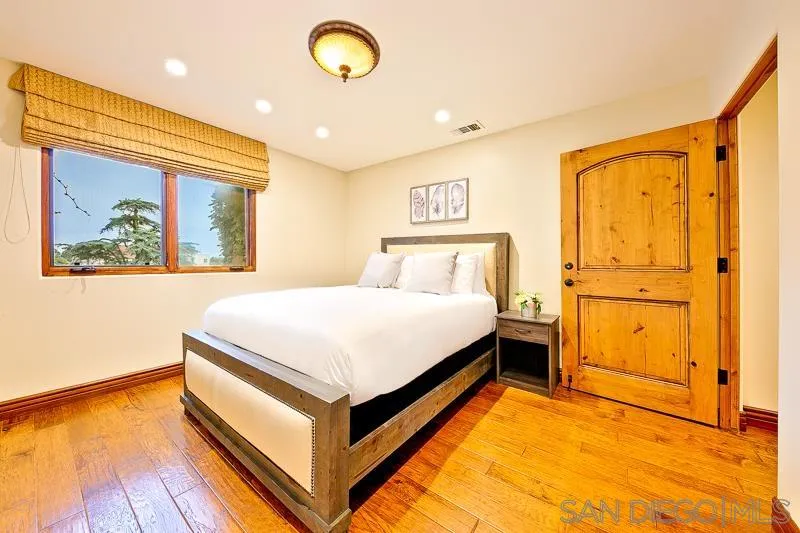 7964 Prospect Place La Jolla, CA 92037 - Photo 35 of 46 a bedroom with a bed and a painting on the wall