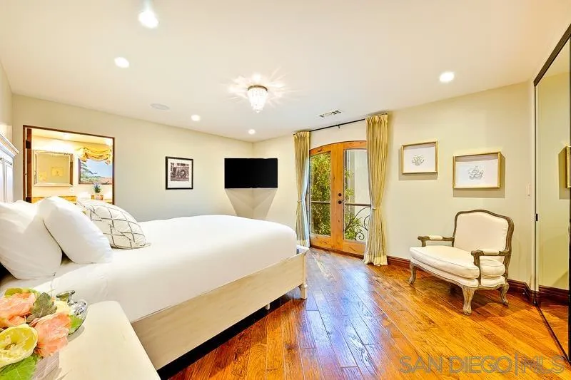 7964 Prospect Place La Jolla, CA 92037 - Photo 37 of 46 a bedroom with a bed and wooden floor