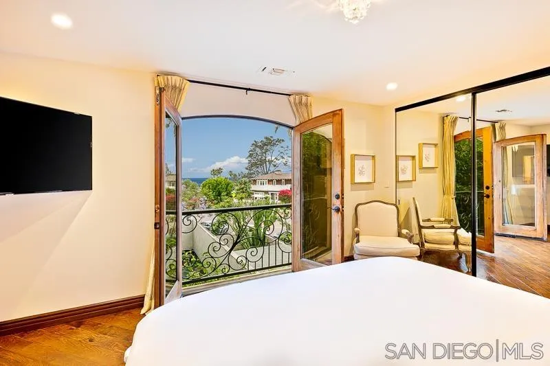 7964 Prospect Place La Jolla, CA 92037 - Photo 39 of 46 a bedroom with a bed window and walk in closet