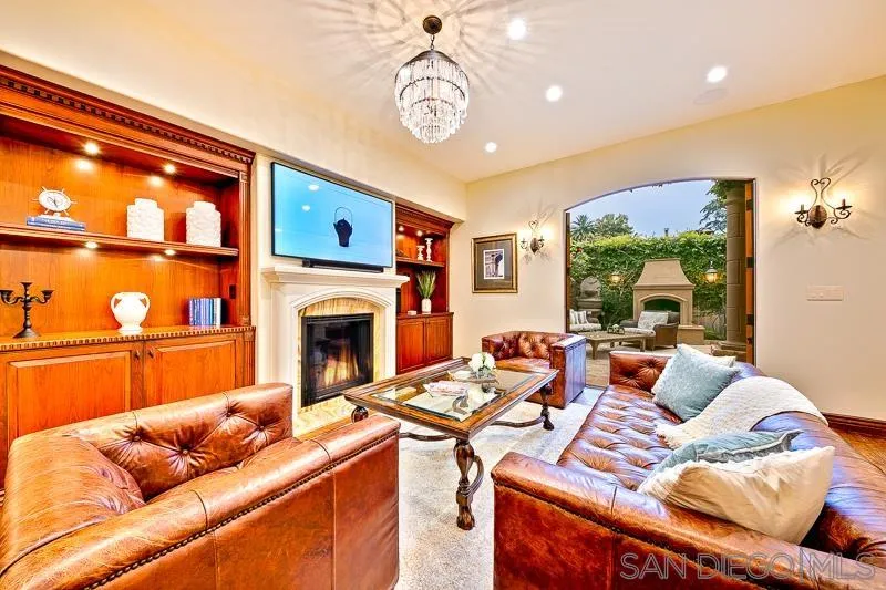 7964 Prospect Place La Jolla, CA 92037 - Photo 5 of 46 a living room with furniture a fireplace and a flat screen tv