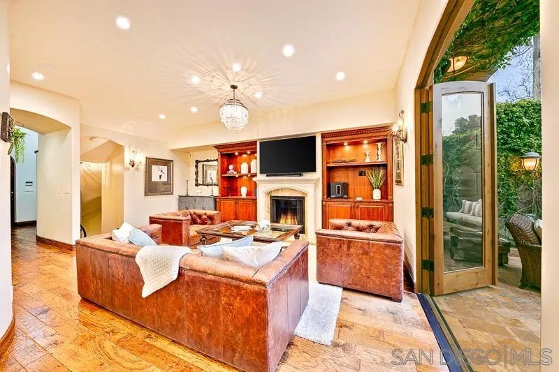 7964 Prospect Place La Jolla, CA 92037 - Photo 6 of 46 a living room with fireplace furniture and a flat screen tv