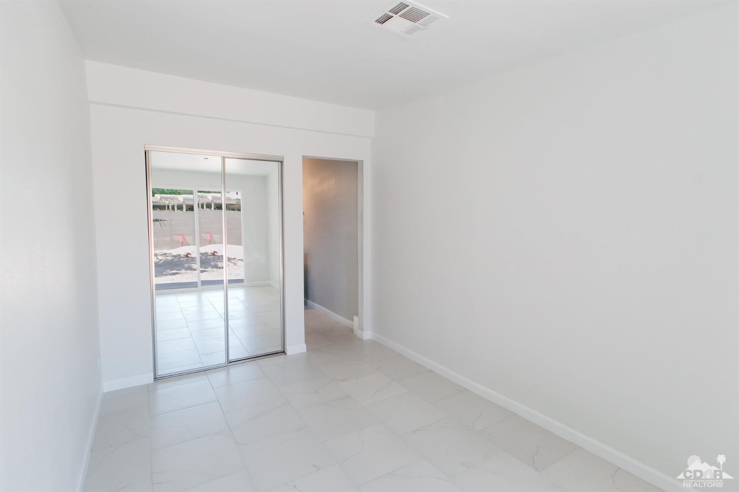 71933 Vista Del Rio Rancho Mirage, CA 92270 - Photo 11 of 32 a view of a refrigerator in kitchen and an empty room