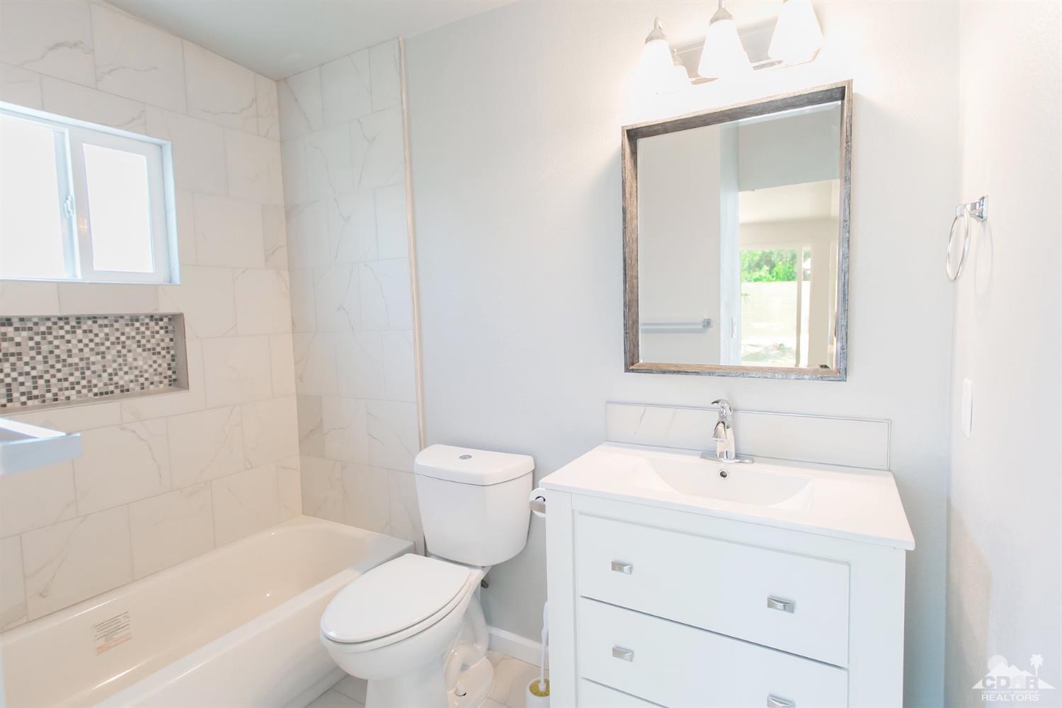 71933 Vista Del Rio Rancho Mirage, CA 92270 - Photo 13 of 32 a white toilet sitting next to a bathroom sink