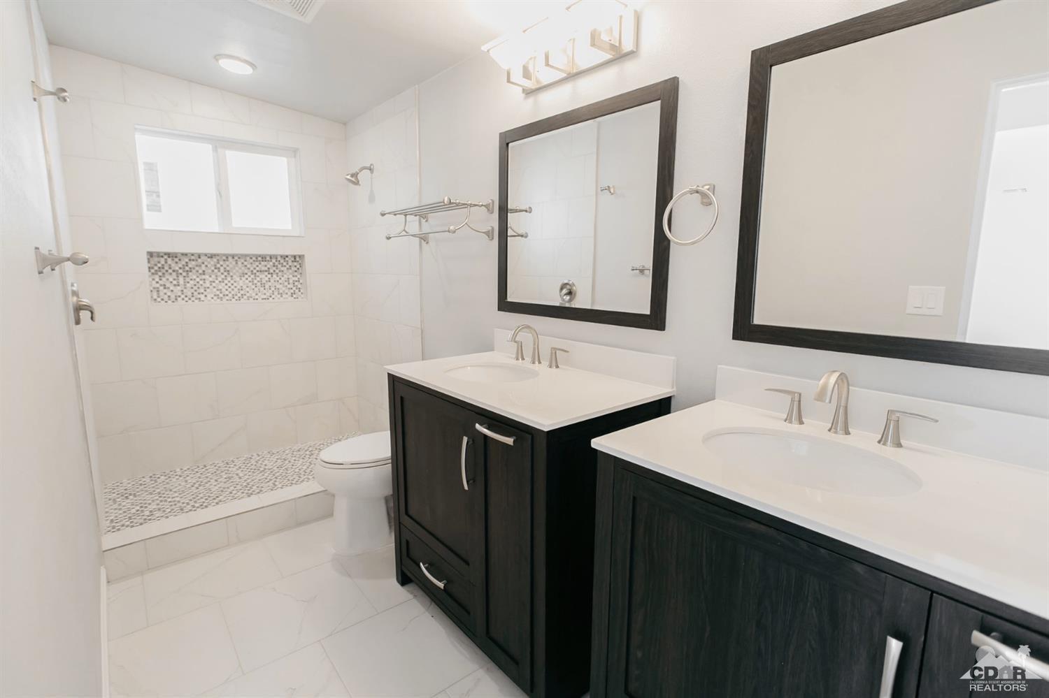 71933 Vista Del Rio Rancho Mirage, CA 92270 - Photo 16 of 32 a bathroom with a sink and a mirror