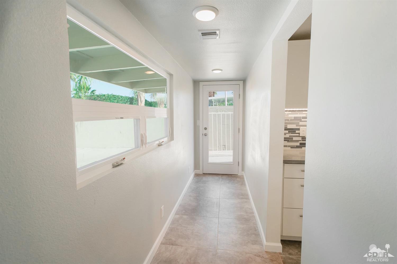 71933 Vista Del Rio Rancho Mirage, CA 92270 - Photo 26 of 32 a view of a hallway with a white walls and a window