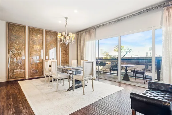 a dining room with wooden floor and large glass table