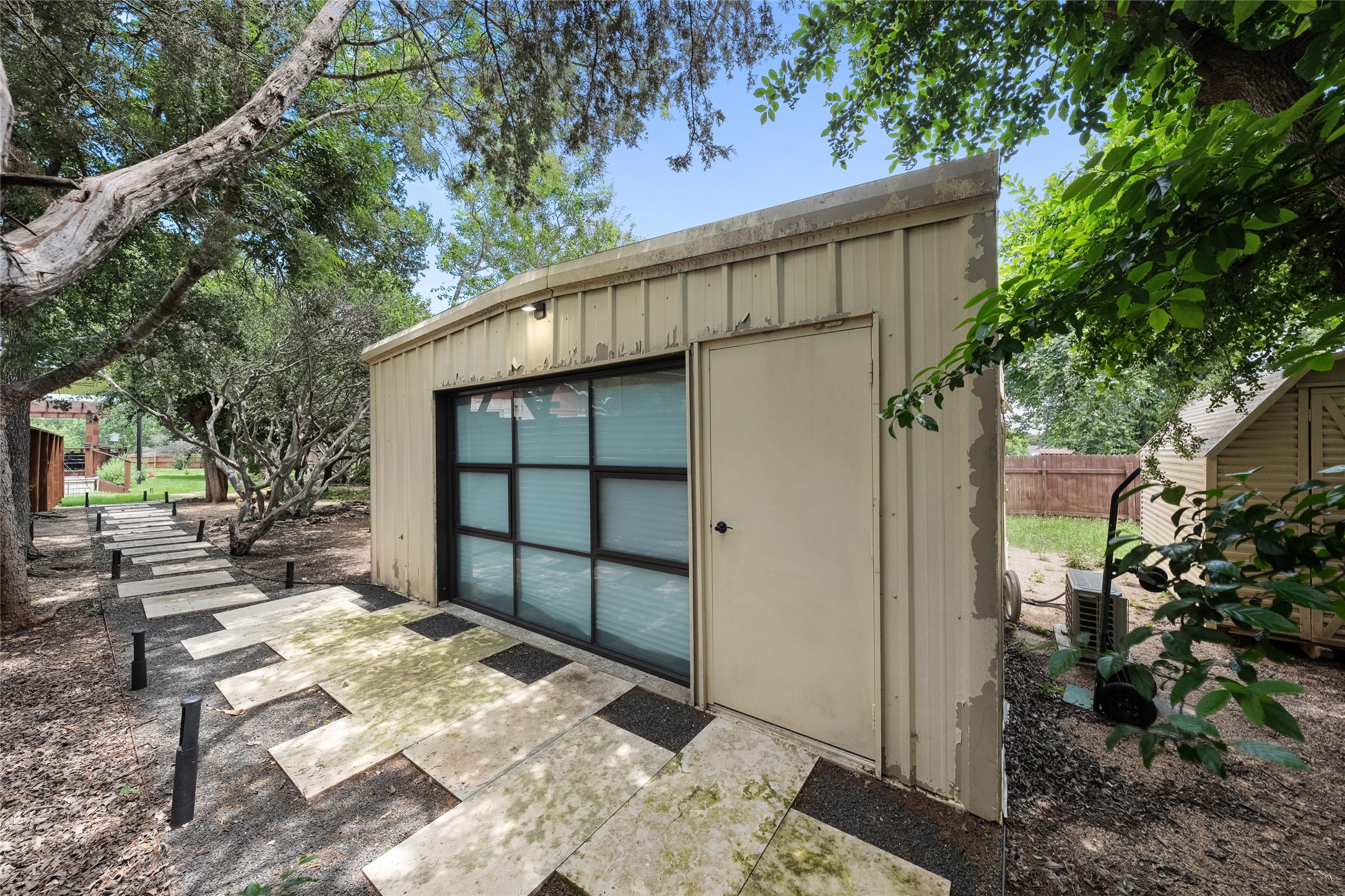 301 Oak Ridge Road Georgetown, TX 78628 - Photo 25 of 34 Detached structure with corrugated metal siding, full-light garage door, and a single entry door