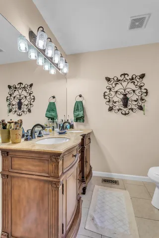 a bathroom with a sink a mirror and a toilet