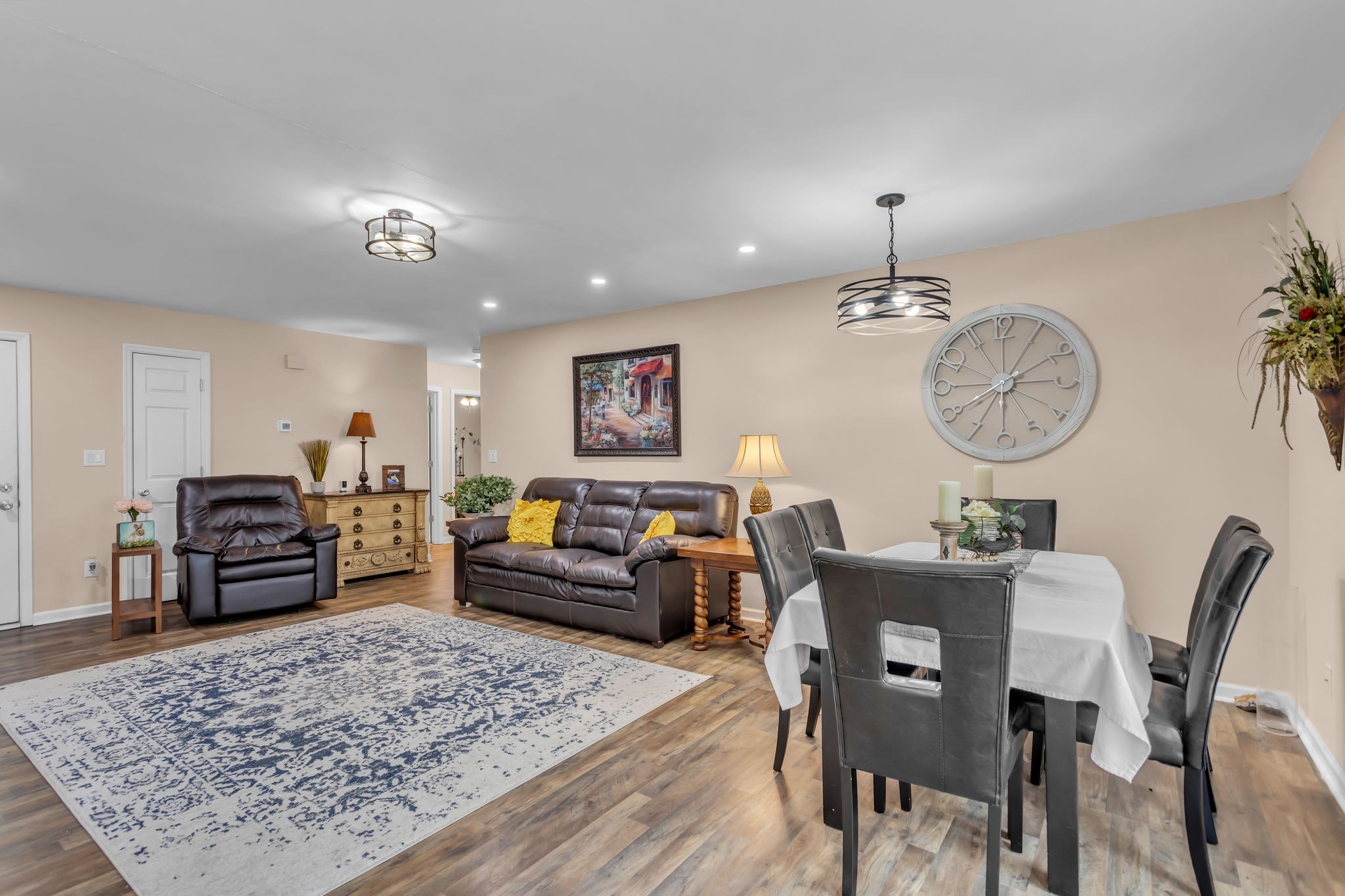 116 Jackson Street Mount Pleasant, TN 38474 - Photo 9 of 27 a living room with furniture a rug a fireplace and a chandelier