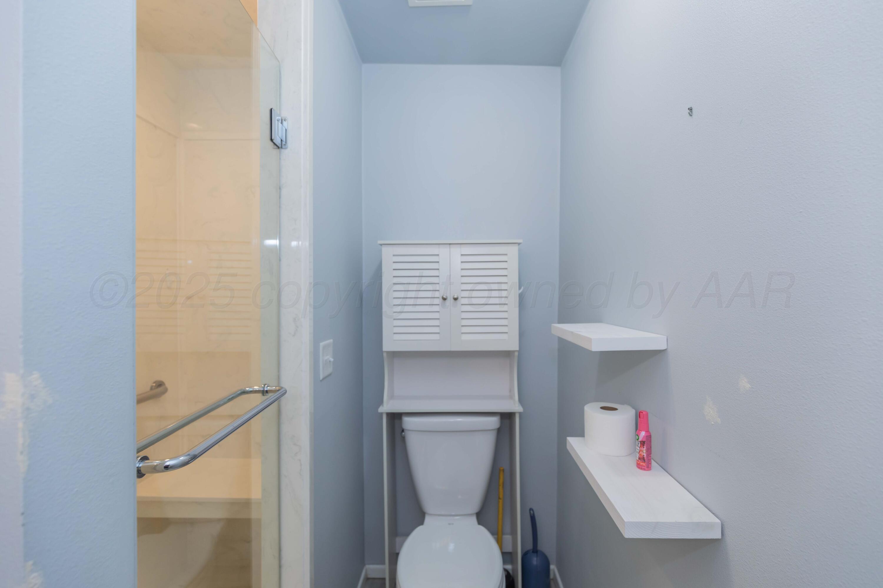 7000 Sunburst Street Amarillo, TX 79110 - Photo 14 of 32 a bathroom with a toilet and a sink