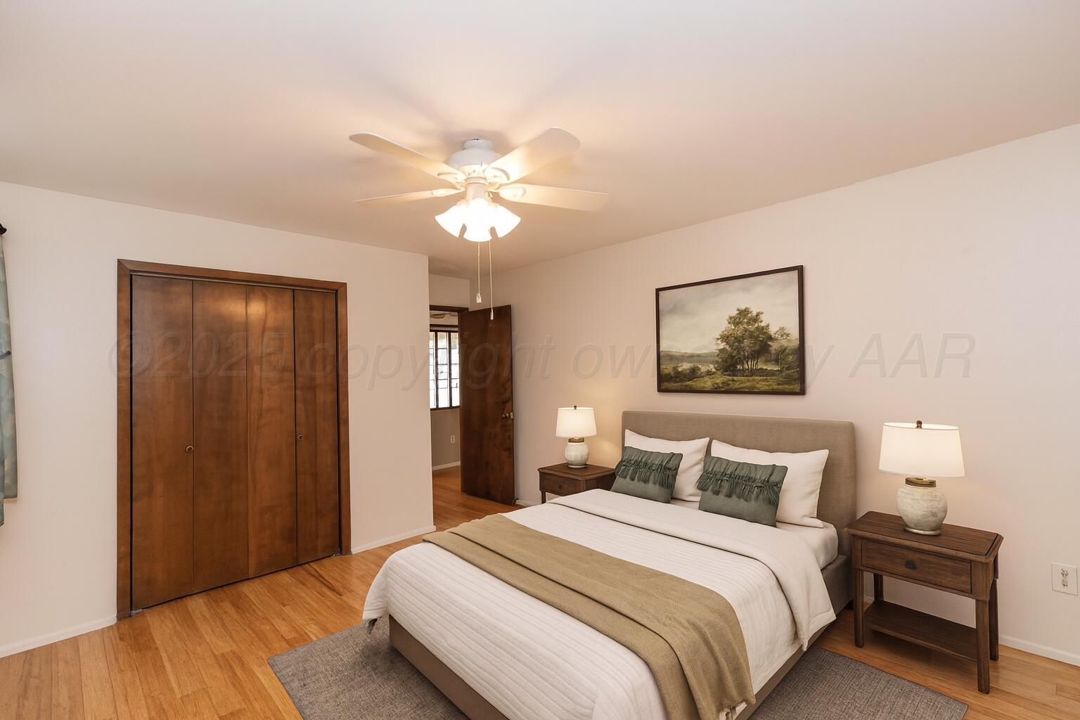 7000 Sunburst Street Amarillo, TX 79110 - Photo 17 of 32 a bedroom with a bed and a painting on the wall