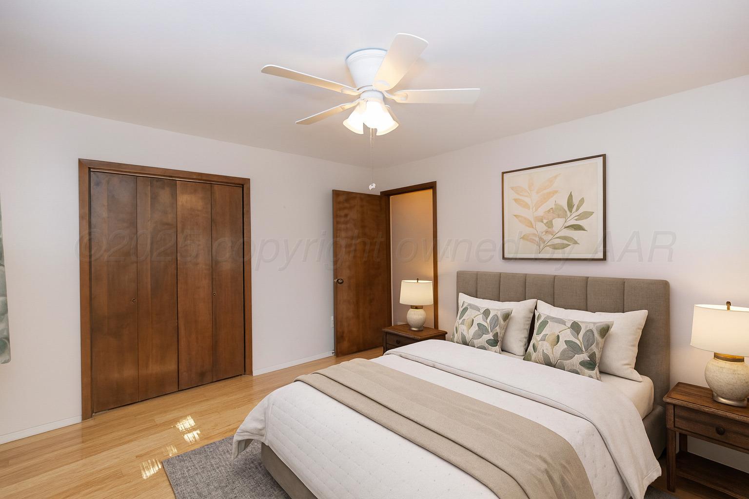 7000 Sunburst Street Amarillo, TX 79110 - Photo 20 of 32 a bedroom with a large bed and a chandelier