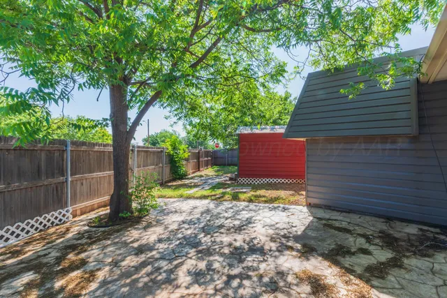 a view of a wooden door and a yard